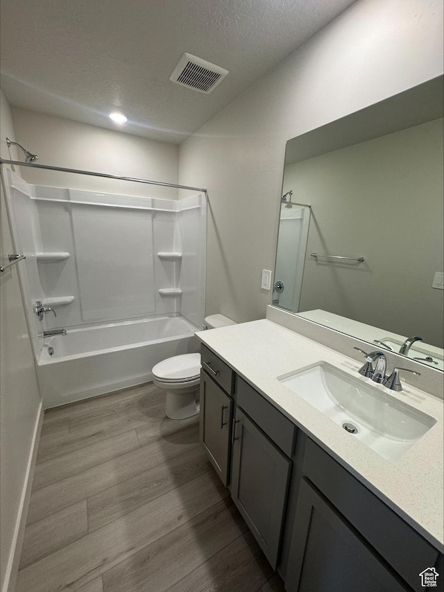 3533 N Browning Unit 1234, Eagle Mountain, UT 84005 - full bathroom featuring vanity, bathing tub / shower combination, wood finished floors, and a textured ceiling