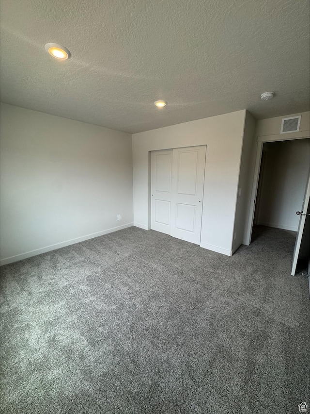 3533 N Browning Unit 1234, Eagle Mountain, UT 84005 - unfurnished bedroom with carpet, a textured ceiling, a closet, and recessed lighting