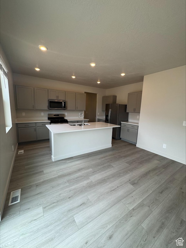 3533 N Browning Unit 1234, Eagle Mountain, UT 84005 - kitchen featuring gray cabinetry, appliances with stainless steel finishes, light wood-style floors, recessed lighting, and light countertops