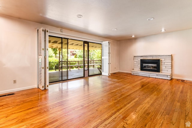 5681 S Calann Dr E, Holladay, UT 84121 - unfurnished living room featuring wood finished floors, recessed lighting, and a stone fireplace