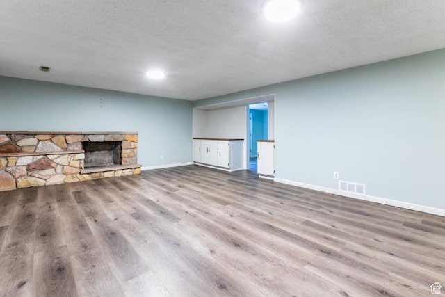 5681 S Calann Dr E, Holladay, UT 84121 - unfurnished living room with wood finished floors and a fireplace