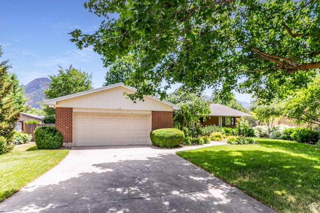 5681 S Calann Dr E, Holladay, UT 84121 - single story home featuring brick siding, a front yard, and concrete driveway