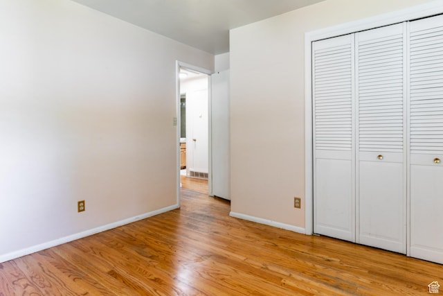 5681 S Calann Dr E, Holladay, UT 84121 - unfurnished bedroom with light wood-style flooring and a closet