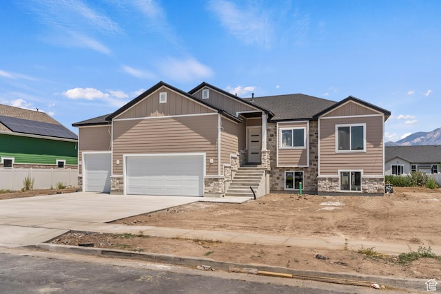 1856 S 2575 W, West Haven, UT 84401 - craftsman house with stone siding, concrete driveway, an attached garage, and board and batten siding