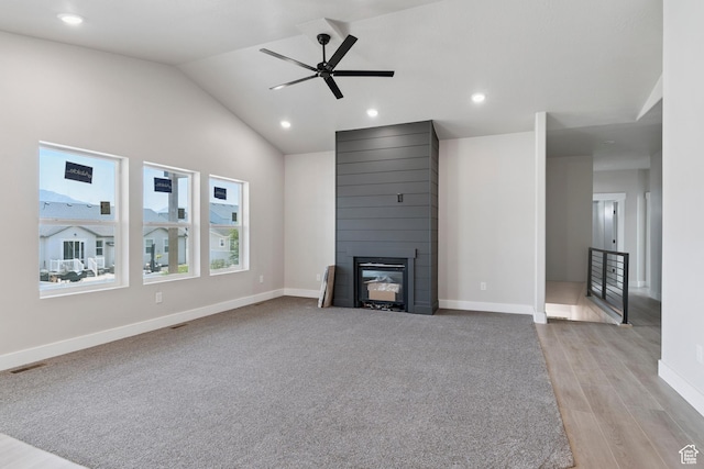 1856 S 2575 W, West Haven, UT 84401 - unfurnished living room with a large fireplace, a ceiling fan, vaulted ceiling, light wood-type flooring, and recessed lighting