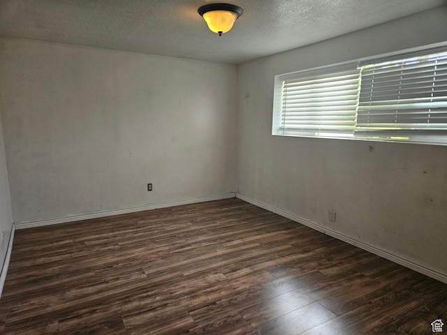3243 S Fairlane St, Magna, UT 84044 - unfurnished room with dark wood finished floors and a textured ceiling