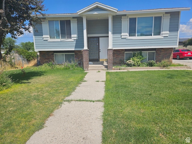 3243 S Fairlane St, Magna, UT 84044 - split foyer home featuring a front yard and brick siding