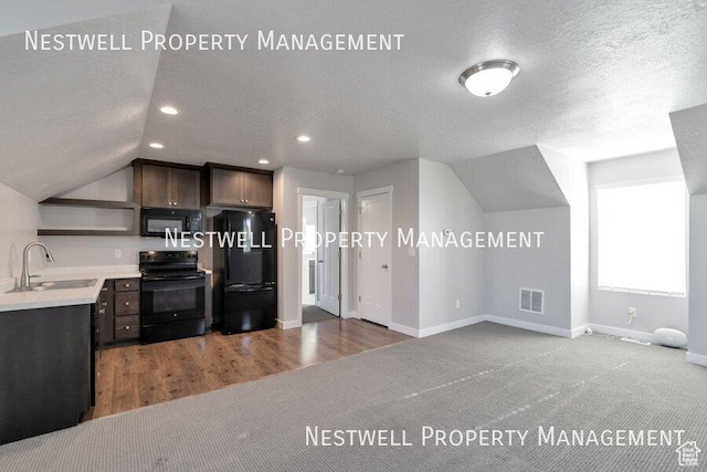 4966 W Kitsap Way Unit 10-532, South Jordan, UT 84009 - kitchen with black appliances, a textured ceiling, open shelves, lofted ceiling, and light countertops