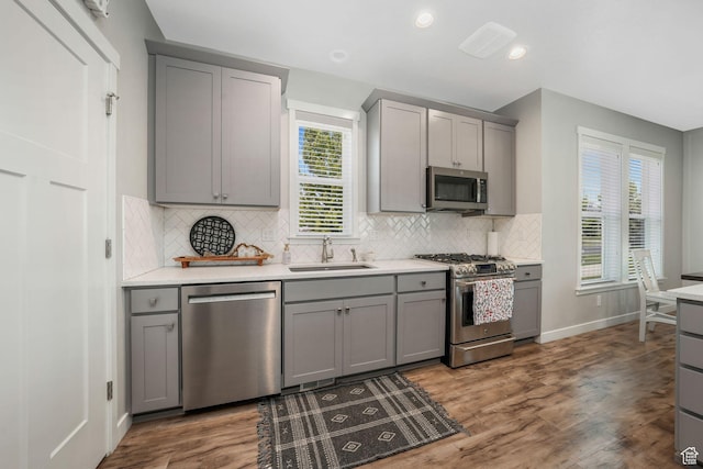 4966 W Kitsap Way Unit 10-532, South Jordan, UT 84009 - kitchen with stainless steel appliances, gray cabinets, wood finished floors, backsplash, and recessed lighting