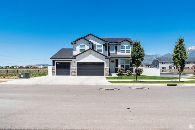 142 W Hackberry Rd, Vineyard, UT 84059 - craftsman house with board and batten siding, solar panels, stone siding, concrete driveway, and an attached garage