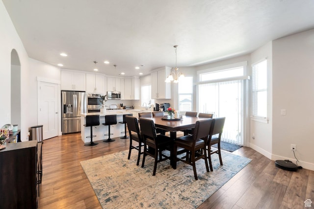 142 W Hackberry Rd, Vineyard, UT 84059 - dining room featuring wood finished floors, recessed lighting, arched walkways, and a chandelier