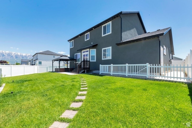 142 W Hackberry Rd, Vineyard, UT 84059 - rear view of property featuring a gazebo, a fenced backyard, and stucco siding