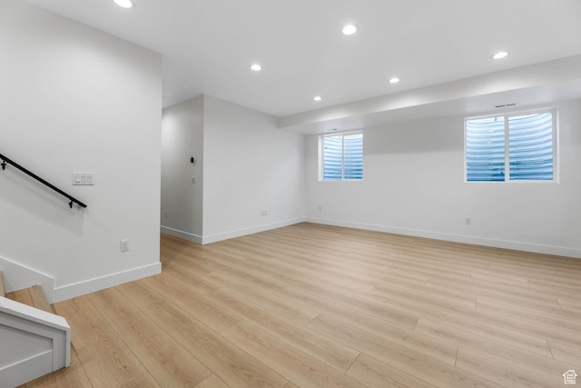 3839 W Saddler Dr, West Jordan, UT 84088 - unfurnished living room with light wood-style floors, recessed lighting, and stairs