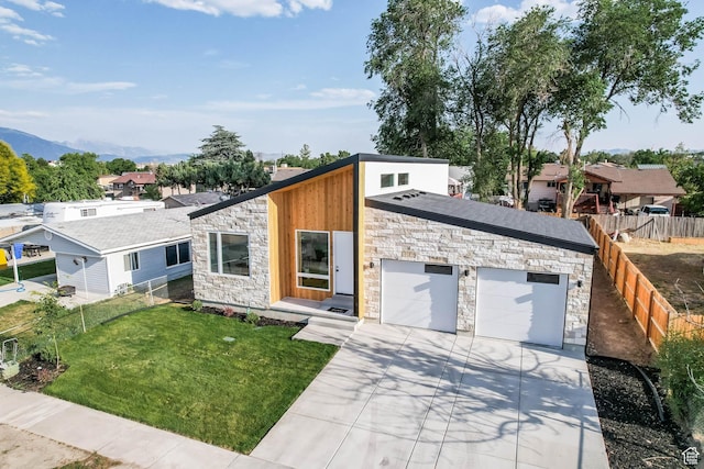 3839 W Saddler Dr, West Jordan, UT 84088 - view of front of property with stone siding, driveway, a mountain view, and an attached garage