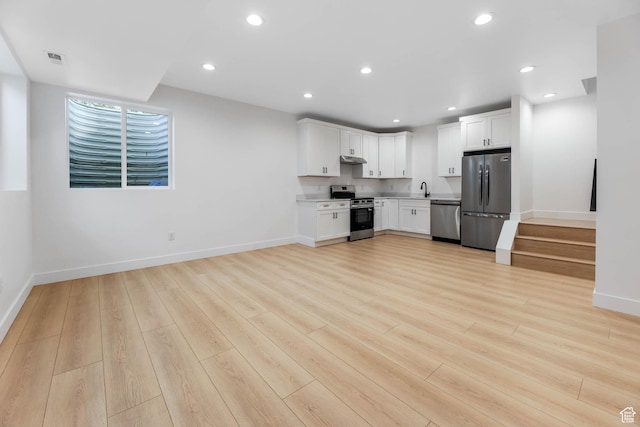 3839 W Saddler Dr, West Jordan, UT 84088 - kitchen with appliances with stainless steel finishes, light wood-style flooring, white cabinetry, recessed lighting, and light countertops