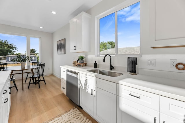 3839 W Saddler Dr, West Jordan, UT 84088 - kitchen featuring dishwasher, light countertops, recessed lighting, light wood-type flooring, and white cabinets