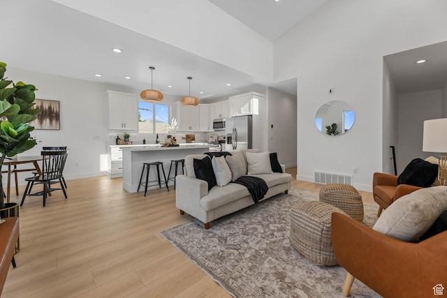 3839 W Saddler Dr, West Jordan, UT 84088 - living room featuring light wood finished floors and recessed lighting