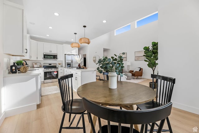 3839 W Saddler Dr, West Jordan, UT 84088 - dining space featuring light wood-type flooring and recessed lighting