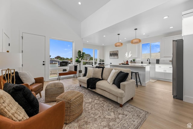 3839 W Saddler Dr, West Jordan, UT 84088 - living room featuring light wood-style flooring, healthy amount of natural light, and recessed lighting