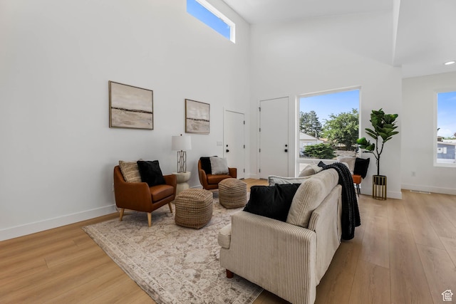 3839 W Saddler Dr, West Jordan, UT 84088 - living area featuring plenty of natural light, light wood-style flooring, and a high ceiling