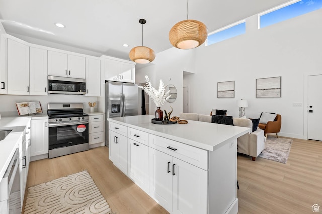 3839 W Saddler Dr, West Jordan, UT 84088 - kitchen featuring appliances with stainless steel finishes, recessed lighting, light countertops, light wood-style floors, and white cabinetry