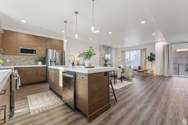 1618 S Main St Unit 3, Salt Lake City, UT 84115 - kitchen with stainless steel appliances, dark wood-style flooring, recessed lighting, backsplash, and light countertops