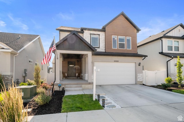 12333 S Pesky Ln, Herriman, UT 84096 - view of front facade featuring an attached garage, concrete driveway, stone siding, and stucco siding