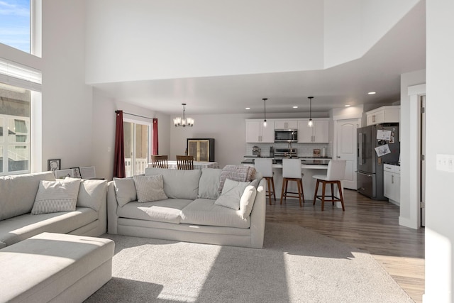12333 S Pesky Ln, Herriman, UT 84096 - living area with a chandelier, wood finished floors, recessed lighting, plenty of natural light, and a towering ceiling