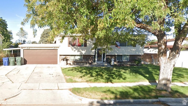 3898 S Ann Dr W, West Valley City, UT 84119 - view of front of house featuring a front lawn, driveway, and a garage