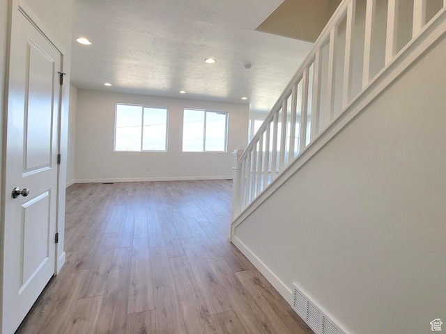 6767 S Glade Creek Dr Unit 230, West Jordan, UT 84081 - foyer entrance with recessed lighting, light wood-style flooring, and stairway