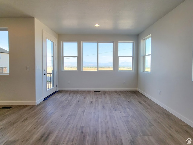 6767 S Glade Creek Dr Unit 230, West Jordan, UT 84081 - unfurnished room with wood finished floors, plenty of natural light, and recessed lighting
