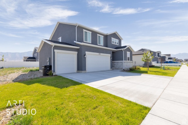 6392 N Wild Mare Way, Stansbury Park, UT 84074 - traditional-style house with a garage, stucco siding, driveway, and a mountain view