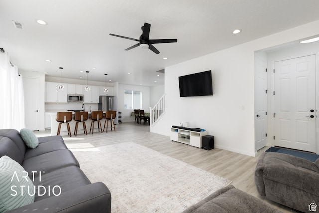 6392 N Wild Mare Way, Stansbury Park, UT 84074 - living area with ceiling fan, stairway, recessed lighting, and light wood-style flooring