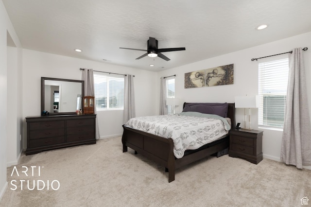 6392 N Wild Mare Way, Stansbury Park, UT 84074 - bedroom with light colored carpet, multiple windows, recessed lighting, and a ceiling fan
