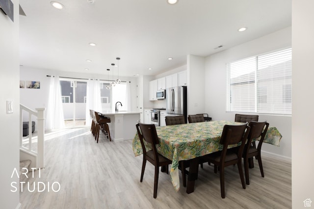 6392 N Wild Mare Way, Stansbury Park, UT 84074 - dining room featuring light wood-style flooring and recessed lighting