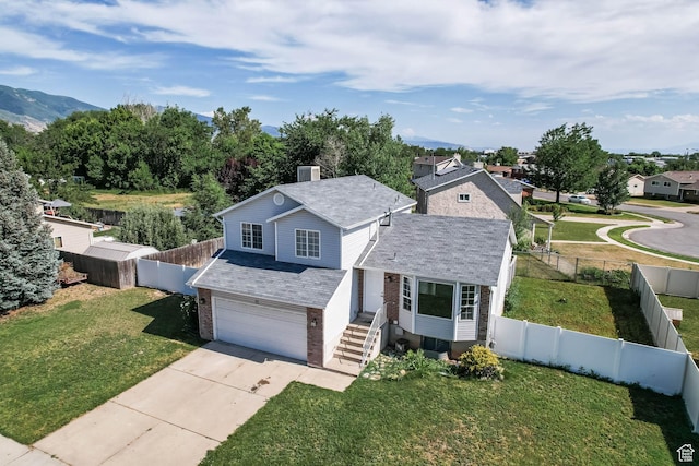 77 W 525 N, Layton, UT 84041 - traditional-style home featuring brick siding, a garage, concrete driveway, a chimney, and a fenced backyard