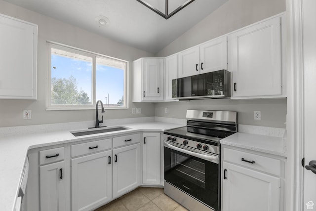 77 W 525 N, Layton, UT 84041 - kitchen featuring appliances with stainless steel finishes, white cabinetry, vaulted ceiling, light countertops, and light tile patterned floors
