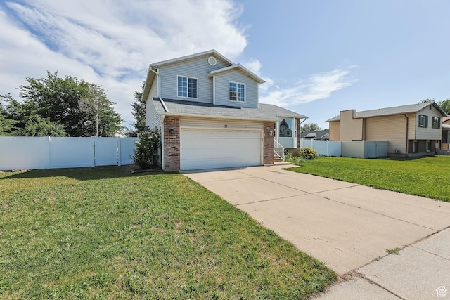 77 W 525 N, Layton, UT 84041 - view of front facade with driveway, brick siding, and an attached garage