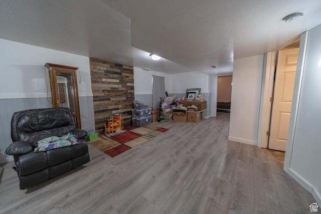 988 N Smith Dr, Price, UT 84501 - living area featuring wood finished floors, a wainscoted wall, wooden walls, and a textured ceiling