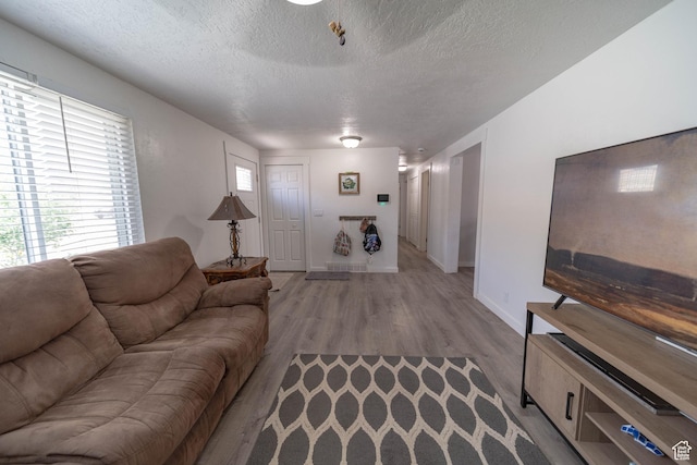 988 N Smith Dr, Price, UT 84501 - living room featuring a textured ceiling and light wood-style floors