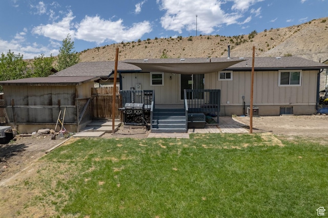 988 N Smith Dr, Price, UT 84501 - rear view of house with a deck with mountain view and board and batten siding