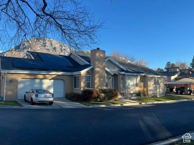 2254 N 390 E, Provo, UT 84604 - single story home with a chimney, a garage, brick siding, and concrete driveway