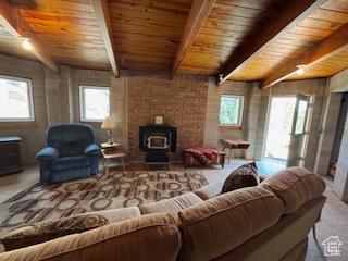 9 Red Cir, Manila, UT 84046 - living room featuring plenty of natural light, a wood ceiling with exposed beams, and a wood stove