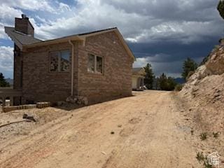 9 Red Cir, Manila, UT 84046 - view of home's exterior featuring a chimney and brick siding