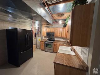 9 Red Cir, Manila, UT 84046 - kitchen featuring stainless steel electric range oven, freestanding refrigerator, light brown cabinetry, and light colored carpet