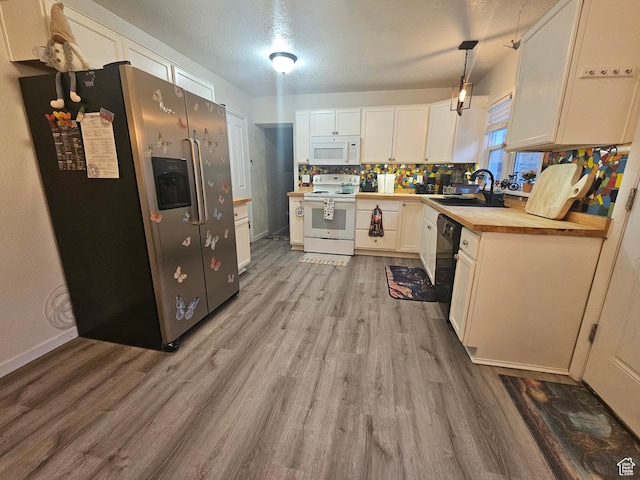 240 N 1400 W, Cedar City, UT 84721 - kitchen with white appliances, wooden counters, light wood-style flooring, white cabinetry, and decorative backsplash