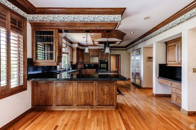 1387 E 260 N, Logan, UT 84321 - kitchen with crown molding, built in refrigerator, light wood finished floors, a peninsula, and glass insert cabinets