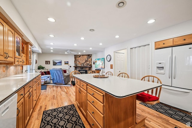 537 E Edindrew Cir, Murray, UT 84107 - kitchen featuring white appliances, a fireplace, a breakfast bar area, recessed lighting, and light wood finished floors