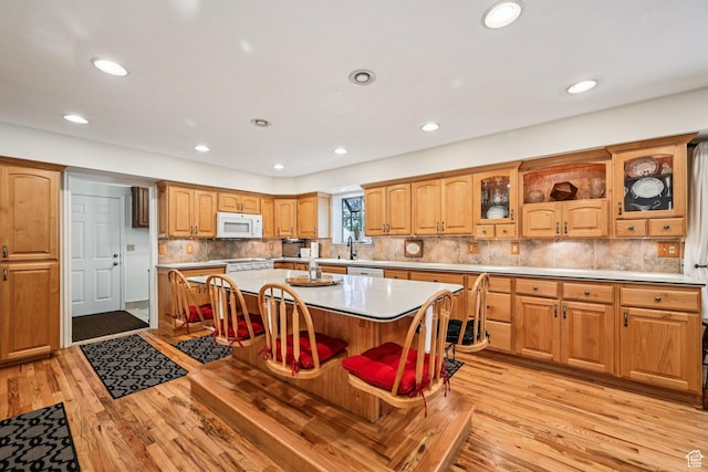 537 E Edindrew Cir, Murray, UT 84107 - kitchen featuring white microwave, light wood finished floors, glass insert cabinets, recessed lighting, and light countertops