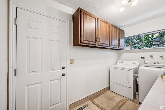 537 E Edindrew Cir, Murray, UT 84107 - laundry area with washer and dryer, cabinet space, and a textured ceiling